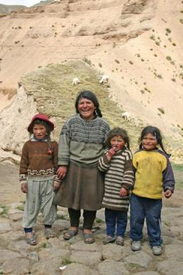 This family lives on hill top above 5000m with their alpacas in the background perched on a cliff.